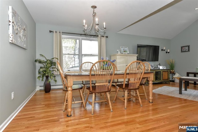 dining room featuring vaulted ceiling, baseboards, a baseboard radiator, light wood finished floors, and a chandelier