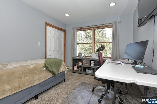 carpeted bedroom with recessed lighting, a baseboard radiator, and a closet