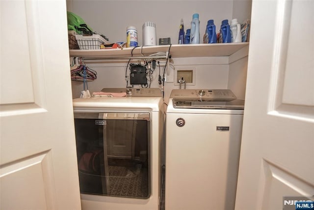 clothes washing area with laundry area and independent washer and dryer