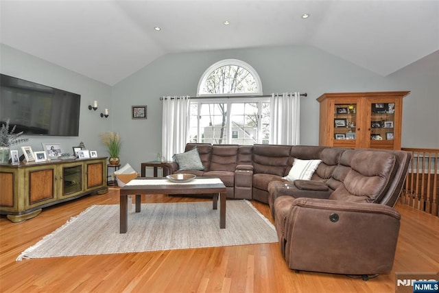 living area featuring light wood-type flooring and lofted ceiling