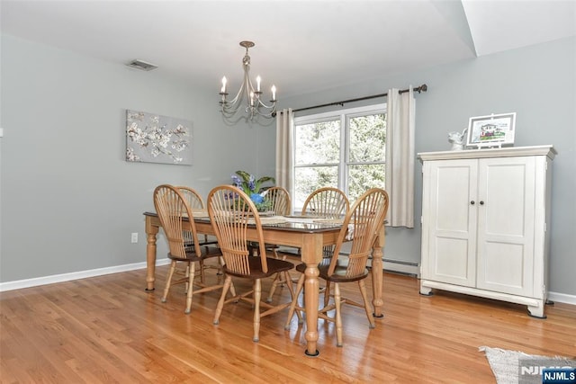 dining space with an inviting chandelier, baseboards, light wood-type flooring, and visible vents
