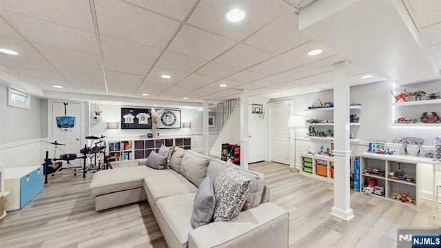 living room with stairs, recessed lighting, and light wood-style floors