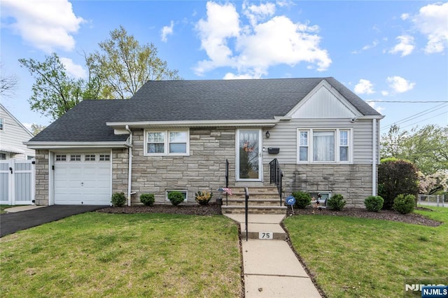 view of front of home featuring a front lawn, an attached garage, stone siding, entry steps, and fence