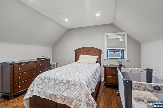 bedroom with radiator heating unit, recessed lighting, vaulted ceiling, dark wood-type flooring, and cooling unit