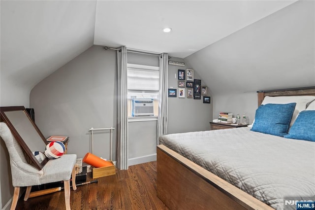 bedroom featuring baseboards, wood finished floors, cooling unit, and vaulted ceiling