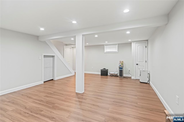 basement with light wood-style floors, recessed lighting, and baseboards