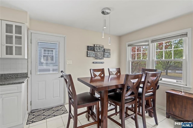 dining room featuring light tile patterned floors and baseboards