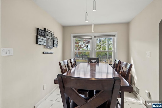 dining space featuring light tile patterned flooring, visible vents, and baseboards