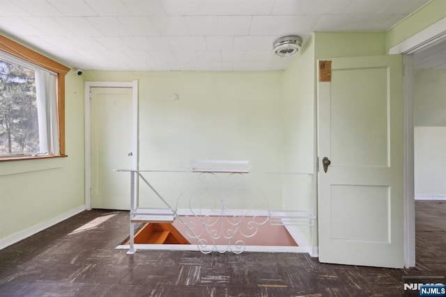 spare room with baseboards