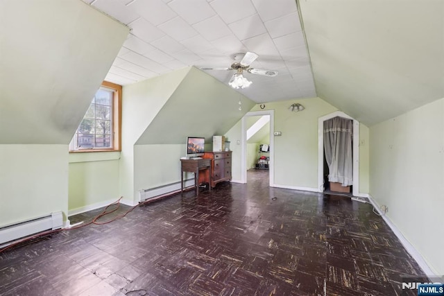 additional living space with ceiling fan, vaulted ceiling, baseboards, baseboard heating, and a baseboard radiator