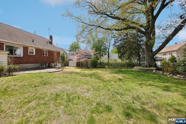 view of yard featuring a patio and fence