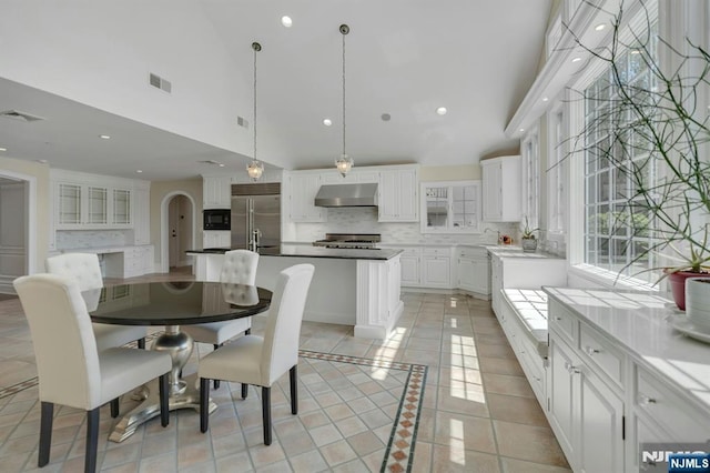 21 Birchwood, Old Tappan, NJ 07675 - dining space featuring high vaulted ceiling, light tile patterned floors, recessed lighting, and arched walkways