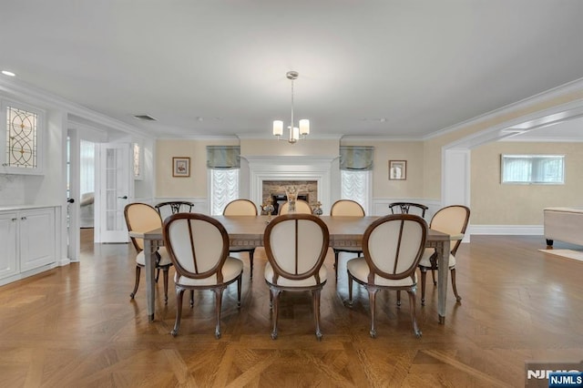 21 Birchwood, Old Tappan, NJ 07675 - dining area with crown molding, a fireplace, baseboards, and a chandelier