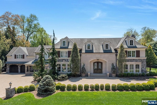 21 Birchwood, Old Tappan, NJ 07675 - french country style house featuring stone siding, french doors, a front yard, and an attached garage