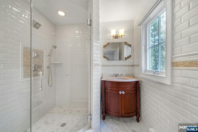 21 Birchwood, Old Tappan, NJ 07675 - full bath with a stall shower, vanity, marble look tile flooring, and tile walls