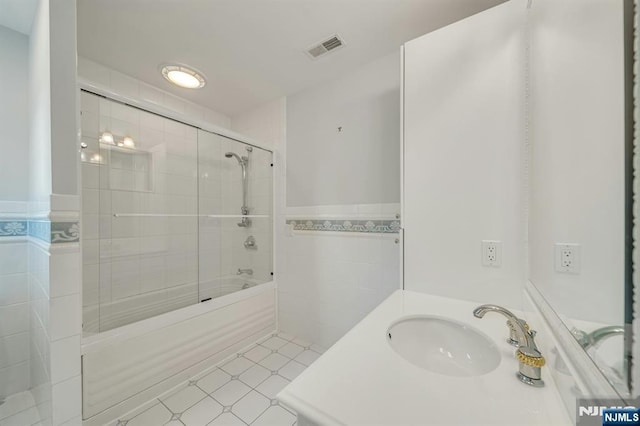 21 Birchwood, Old Tappan, NJ 07675 - full bath with tile walls, bath / shower combo with glass door, a wainscoted wall, and vanity