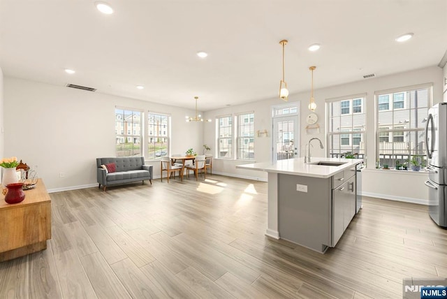 4 Arnold Dr, Wood Ridge, NJ 07075 - kitchen featuring a sink, light countertops, gray cabinetry, stainless steel appliances, and light wood-style flooring