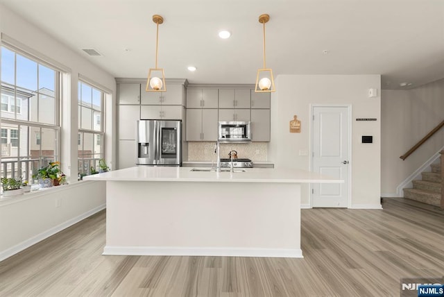 4 Arnold Dr, Wood Ridge, NJ 07075 - kitchen with gray cabinetry, appliances with stainless steel finishes, light wood finished floors, and light countertops