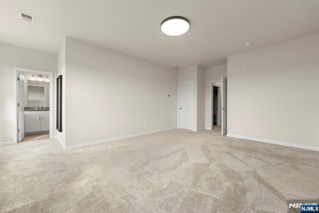 4 Arnold Dr, Wood Ridge, NJ 07075 - unfurnished bedroom featuring visible vents, light carpet, baseboards, a sink, and ensuite bath