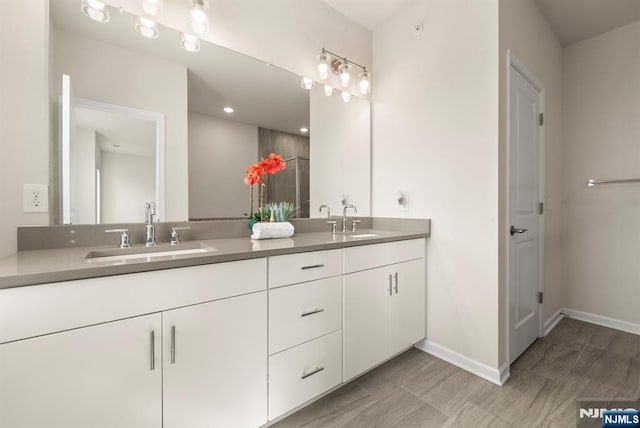 4 Arnold Dr, Wood Ridge, NJ 07075 - full bathroom with double vanity, baseboards, and a sink