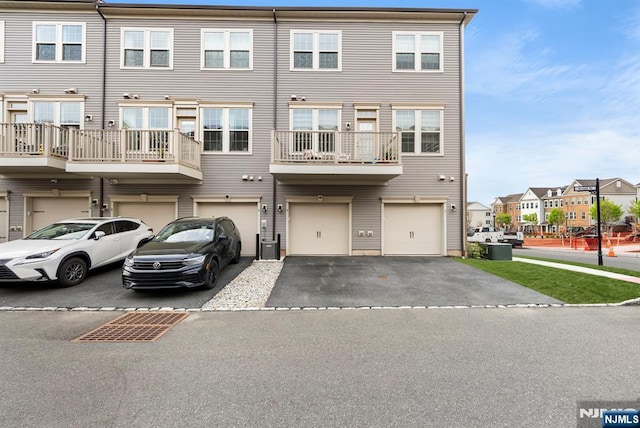 4 Arnold Dr, Wood Ridge, NJ 07075 - view of front facade featuring a garage, central air condition unit, driveway, and a residential view