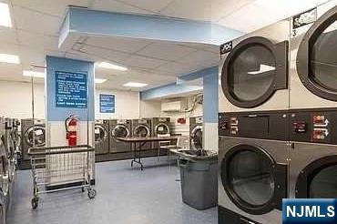 community laundry room with stacked washer and clothes dryer