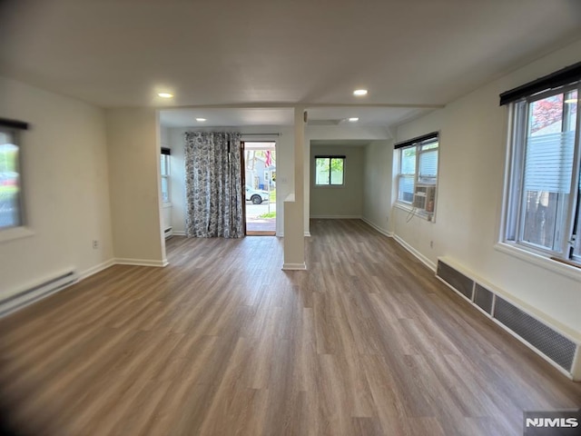 46 Park Dr, Oakland, NJ 07436 - unfurnished living room featuring visible vents, wood finished floors, baseboards, recessed lighting, and a baseboard heating unit