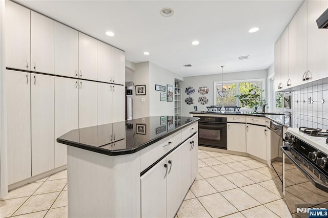 kitchen featuring light tile patterned floors, range hood, black appliances, and recessed lighting