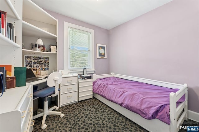 bedroom with dark colored carpet