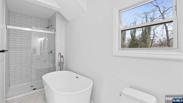 full bathroom with a stall shower, toilet, and a soaking tub