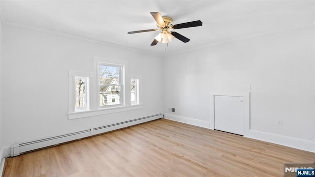 unfurnished room featuring crown molding, a ceiling fan, wood finished floors, and a baseboard radiator