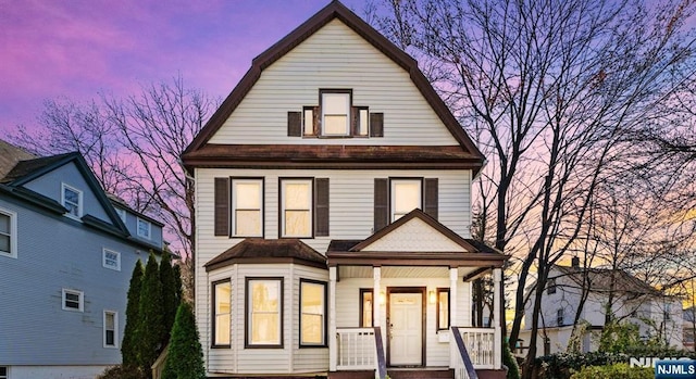 view of front of property featuring covered porch and a gambrel roof