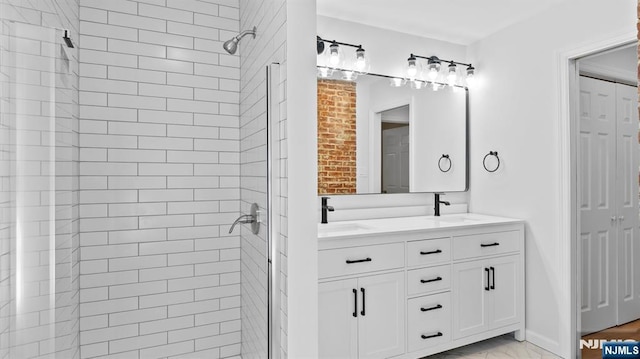 full bathroom featuring a sink, a shower stall, double vanity, and marble finish floor
