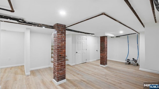 finished basement featuring baseboards and wood finished floors