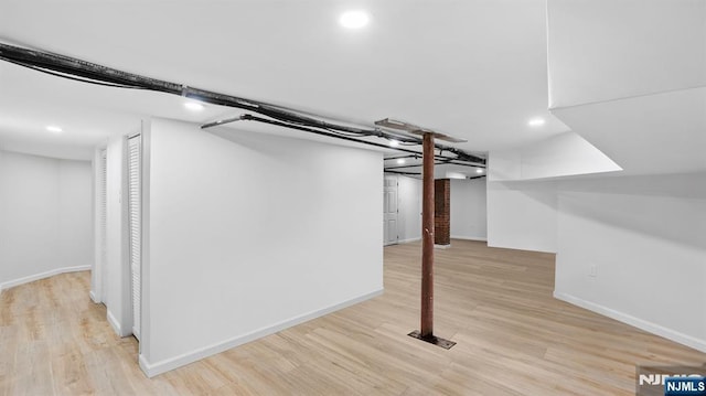 finished basement with recessed lighting, baseboards, and light wood-style floors