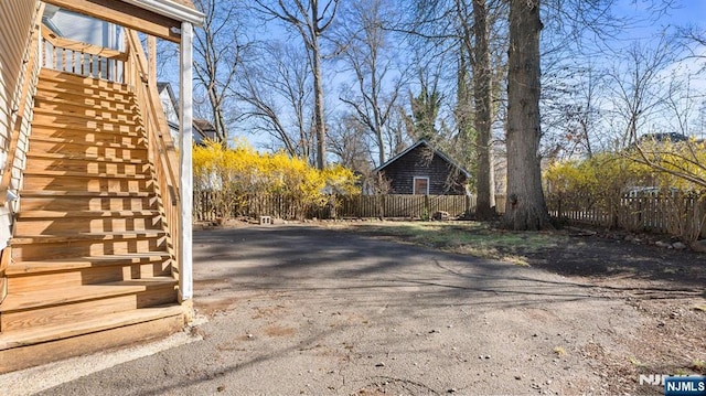 exterior space featuring stairway and driveway