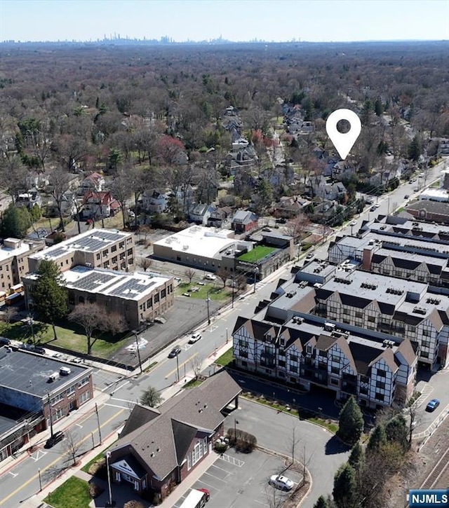 drone / aerial view featuring a forest view