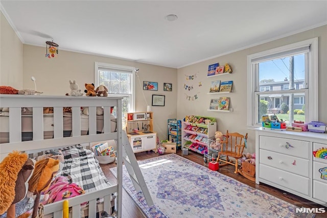 bedroom with crown molding and wood finished floors