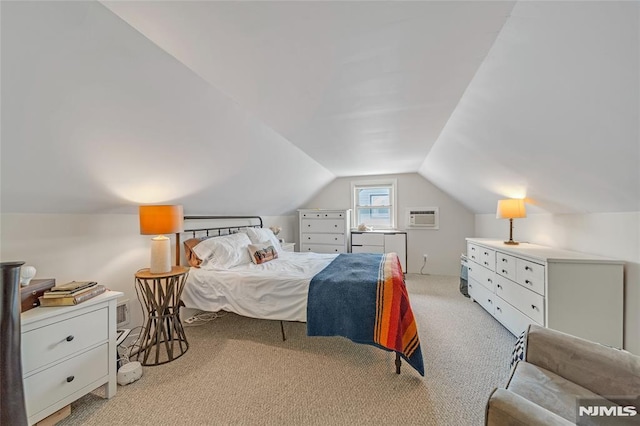 bedroom featuring light colored carpet, a wall unit AC, and vaulted ceiling