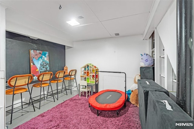 rec room with visible vents and finished concrete floors