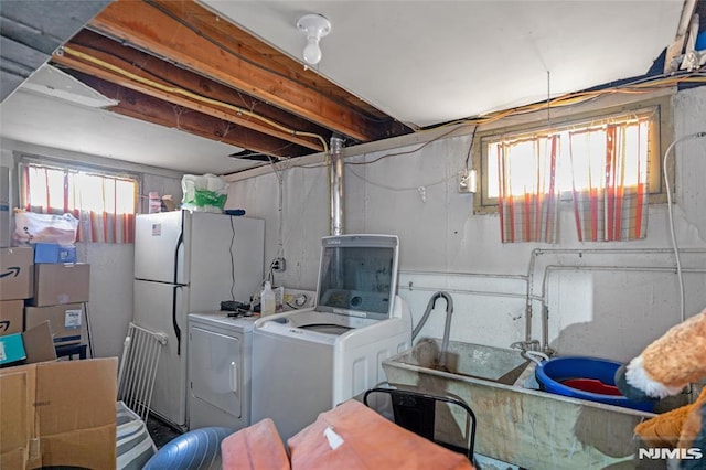 clothes washing area featuring laundry area and washer and clothes dryer
