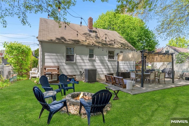 back of house with cooling unit, a fenced backyard, a yard, a patio, and a fire pit