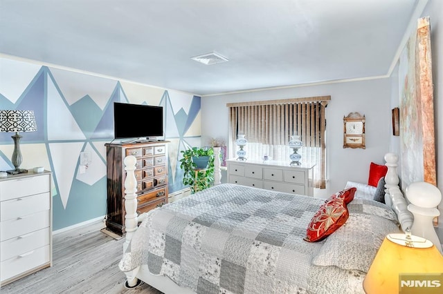 bedroom featuring visible vents, ornamental molding, baseboards, and wood finished floors