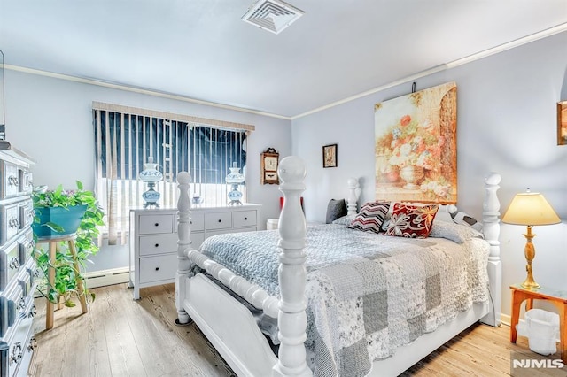 bedroom featuring crown molding, baseboards, visible vents, and wood finished floors