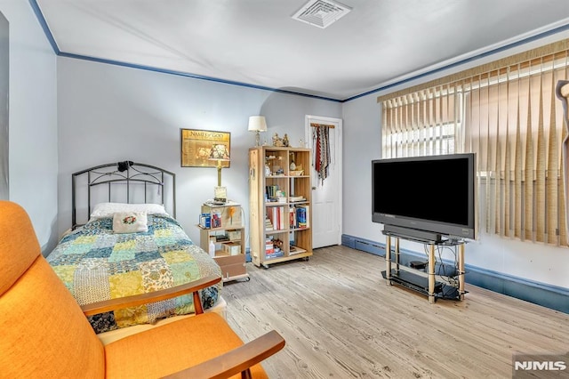 bedroom with wood finished floors and visible vents