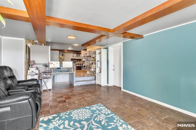 living room with baseboards and beam ceiling