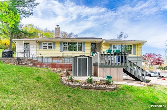 back of property featuring a chimney, a wooden deck, a yard, and stairway