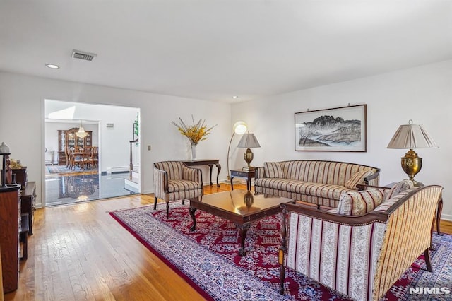 living room with wood-type flooring, recessed lighting, baseboards, and visible vents