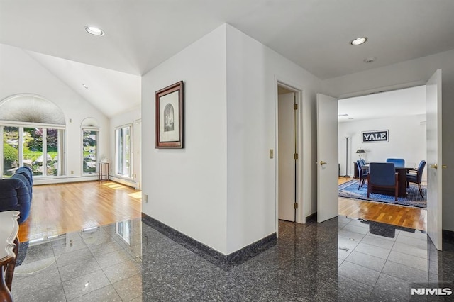 corridor featuring recessed lighting, baseboards, granite finish floor, and lofted ceiling
