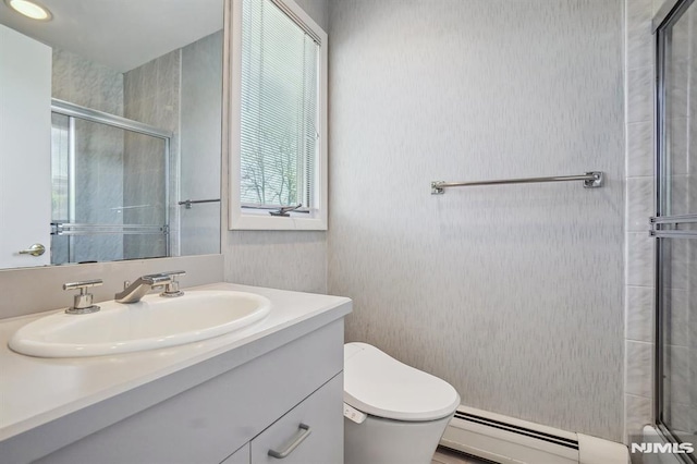full bath with vanity, a baseboard radiator, a tile shower, and toilet
